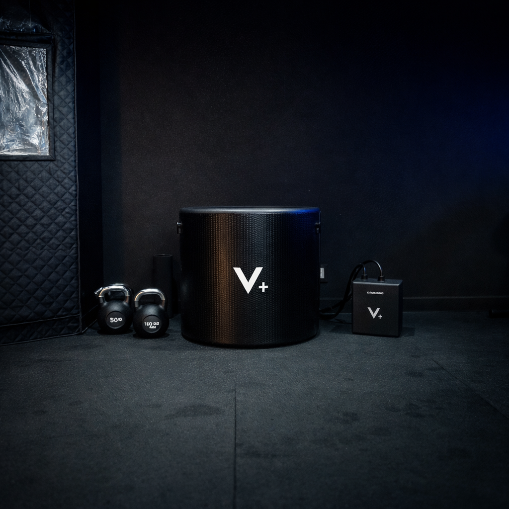 Black ice bath with chiller with 'V+' logo in a dark room
