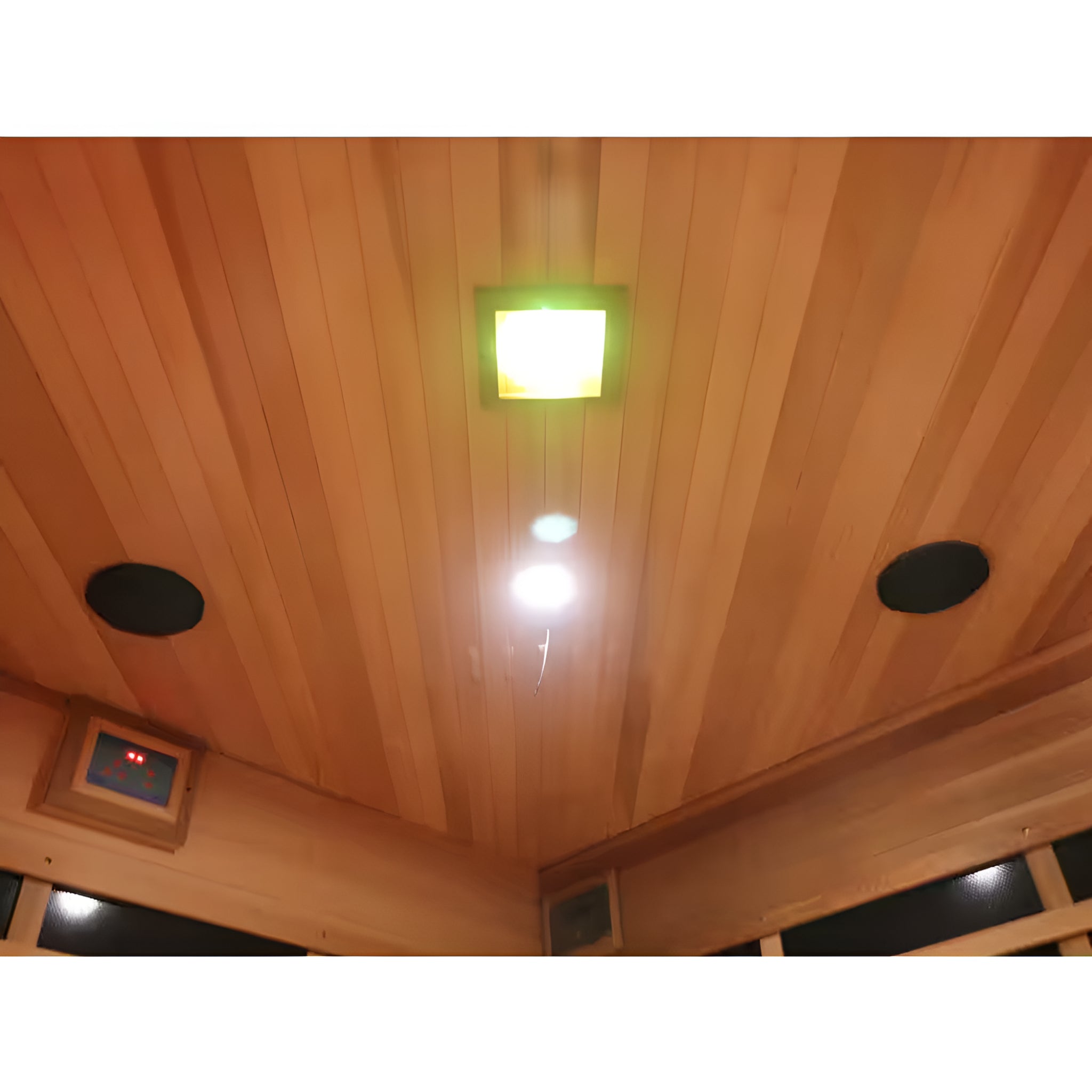 Wooden sauna ceiling with a light fixture and speakers
