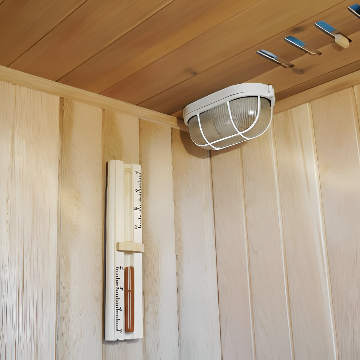 Ceiling light fixture in a wooden sauna with a thermometer on the wall.